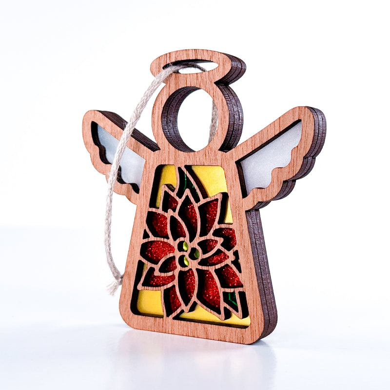 The PREORDERS CLOSED! Poinsettia Ornament by Forged Flare® is a 3.5" handmade wooden angel from Mother's Angels®, featuring white wings, a red glitter poinsettia, and a string loop—ideal for charming Christmas tree décor.