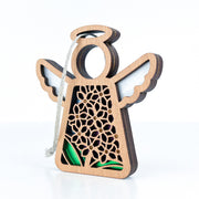 The Forged Flare® Mother's Angels® Purple Lilac Ornament is a 3.5" angel figurine featuring floral cutouts, white wings, a halo, and hanging string—an elegant Christmas tree decoration shown against a white background.