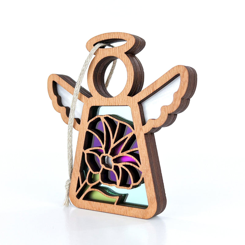 The Purple Morning Glory Ornament by Forged Flare® is a 3.5" wooden angel figurine with cut-out wings, vibrant stained glass accents, and a hanging string—an ideal birth flower keepsake from the Mother's Angels® collection.