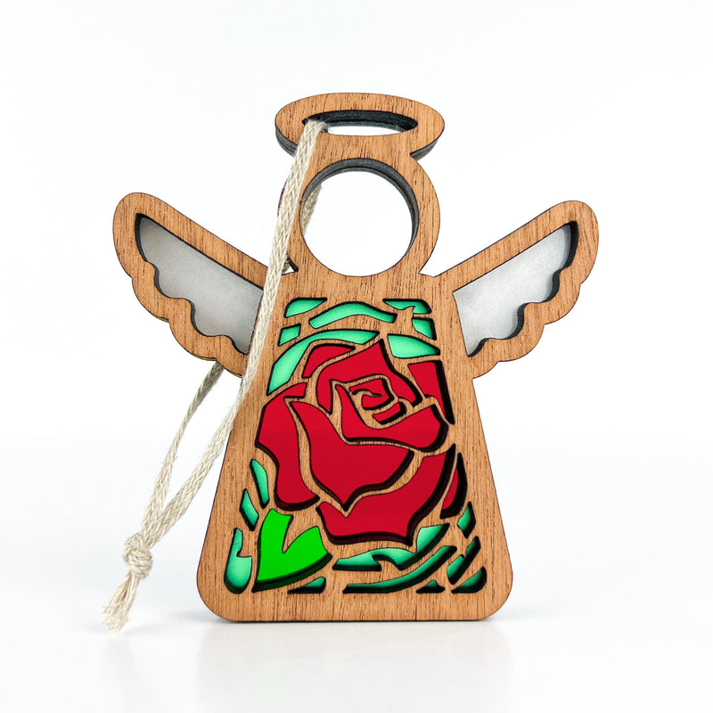 The Forged Flare® Mother's Angels® Red Rose Ornament with Imperfections is a 3.5" handcrafted angel figurine featuring cut-out wings, a circular halo, a red rose centerpiece, green leaves, and a white hanging string.