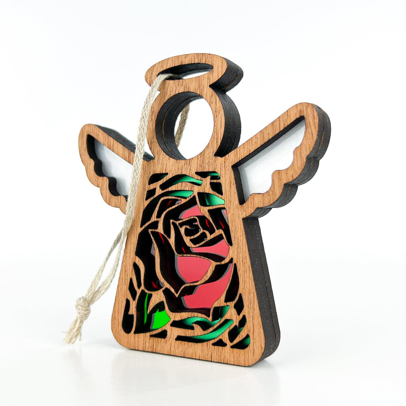The Forged Flare® Mother's Angels® Red Rose Ornament with Imperfections is a 3.5" handcrafted wooden angel figurine featuring a red rose centerpiece, cutout detailing, and a string loop for hanging, displayed on a plain white background.