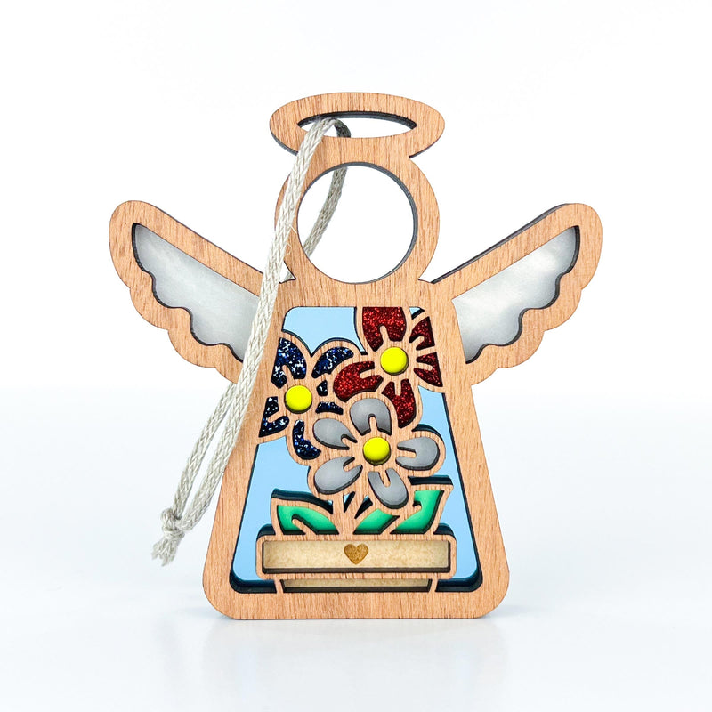 The Forged Flare® Red, White & Bloom Ornament is a 3.5" wooden angel figurine with glittery flower cutouts and elegant wings. Great as a Christmas tree ornament or to add charm to patriotic gifts from the Mother's Angels® collection.