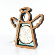 The Forged Flare® Mother's Angels® Sand Dollar Ornament with Imperfections is a 3.5" handcrafted angel figurine featuring open wings, a halo, rope hanging loop, and a sand dollar centerpiece set against a teal background.