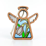 The Forged Flare® Mother's Angels® Snowdrop Ornament is a 3.5" wooden angel figurine with white wings, a halo, a stained-glass style snowdrop flower panel, green leaves on blue, and an attached string for hanging.