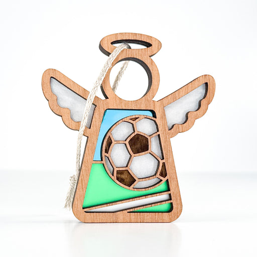 The Forged Flare® Mother's Angels® Soccer Ornament is a 3.5" wooden angel figurine with a soccer ball, green-blue accents, cut-out wings, halo, and hanging string—an ideal soccer lover gift.