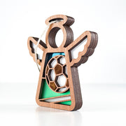 The Forged Flare® Mother's Angels® Soccer Ornament is a 3.5" wooden angel figurine with cutout wings, a soccer ball centerpiece, and green accents—perfect as a soccer goalie ornament.