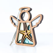 The Starfish Ornament by Forged Flare® is a 3.5" wooden Mother's Angels® figurine with layered details, white wings, and yellow-blue glass-like accents—ideal as unique beach house décor or a thoughtful gift.