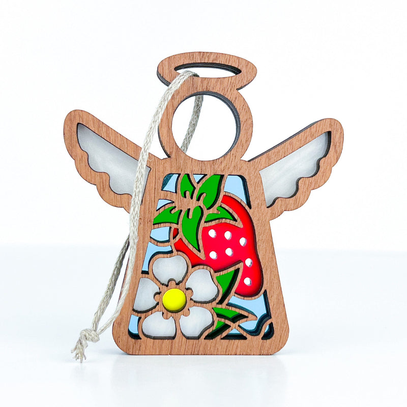 The Forged Flare® Strawberry Ornament is a 3.5" wooden Mother's Angels® figurine featuring a colorful red strawberry and white flower design, with simple outlined wings and halo—perfect for holiday or Christmas tree decor.