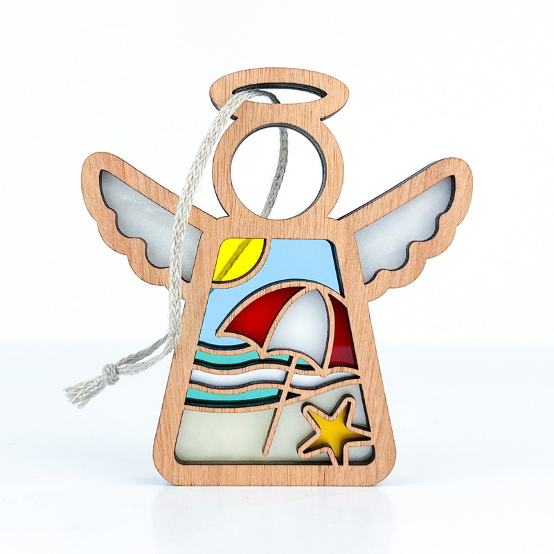 The Forged Flare® Summer Beach Ornament is a 3.5" stained-glass-style angel figurine by Mother's Angels® featuring waves, sun, umbrella, and starfish. Perfect for Christmas trees or beach house decor with a handy hanging string.