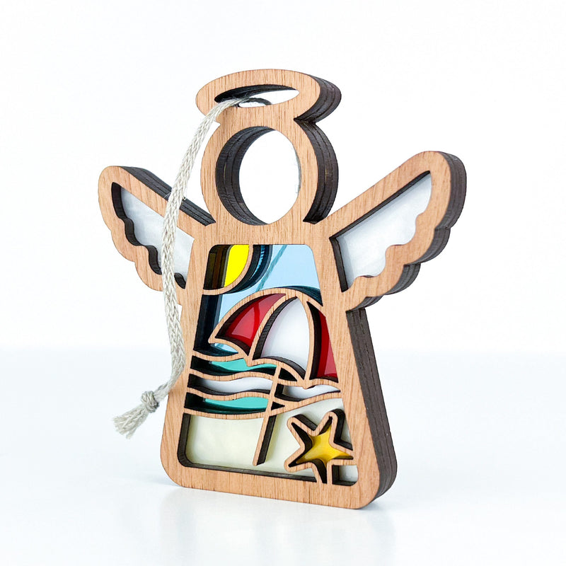 The Forged Flare® Summer Beach Ornament, a 3.5" Mother's Angels® angel figurine with stained-glass beach details—umbrella, sun, waves, and starfish—is perfect for your tree or beach house decor and comes ready to hang.