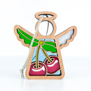 The Sweet Cherries Ornament by Forged Flare® is a 3.5" Mother's Angels® figurine with a halo and wings, stained glass-style cherries and green leaves, plus a gray string for easy hanging—a unique Christmas ornament for your tree.