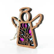 The Forged Flare® Sweet Pea Ornament is a 3.5" wooden angel figurine with cutout wings, floral patterns, purple and blue glass-like accents, and a hanging string—part of the Mother's Angels® collection.