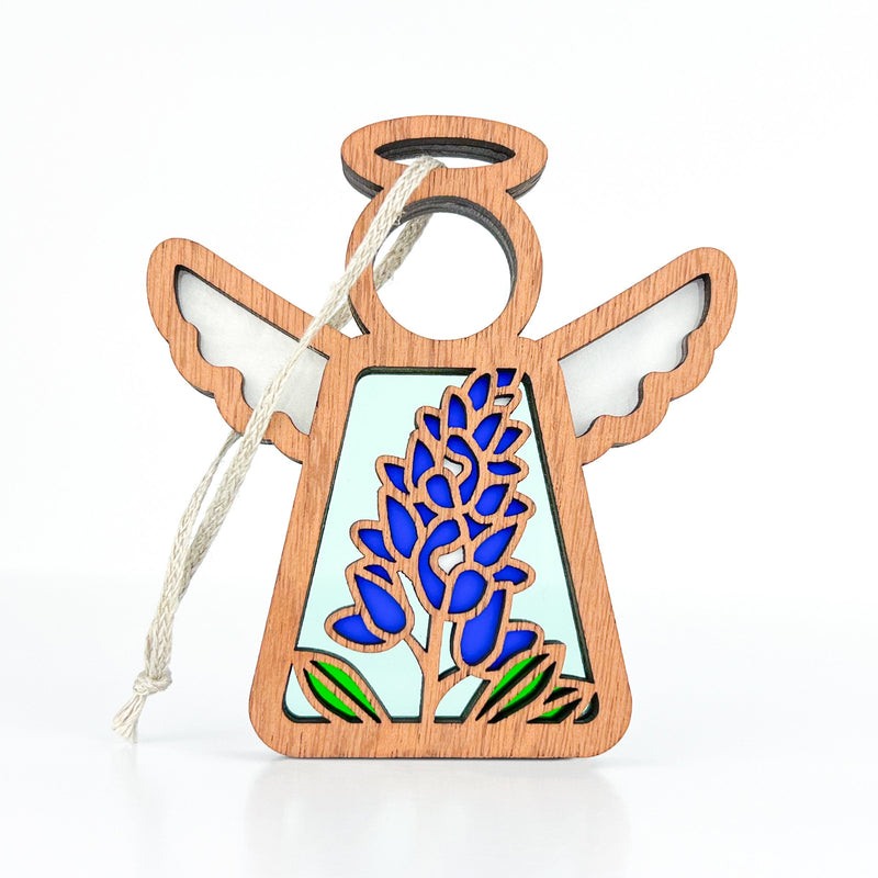 The Forged Flare® Texas Bluebonnet Ornament is a 3.5" Mother's Angels® figurine with a wooden angel, halo, and stained glass-style bluebonnet flower. Includes a hanging loop; perfect floral decor against any background.