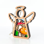 The Forged Flare® Mother's Angels® Toadstool Mushroom Ornament is a 3.5" angel-shaped wooden figurine with cutout wings and halo, colorful toadstools and greenery inside, plus a white hanging string. Plain white background.
