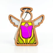 A Mother's Angels® 3.5" angel figurine from Forged Flare®, this Tulip Ornament features intricate wooden wings and a halo, with a stained glass-like body design. This Christmas tree decoration includes a vibrant purple tulip accented with yellow, pink, and green hues. It comes with a white string for hanging against its plain white background.