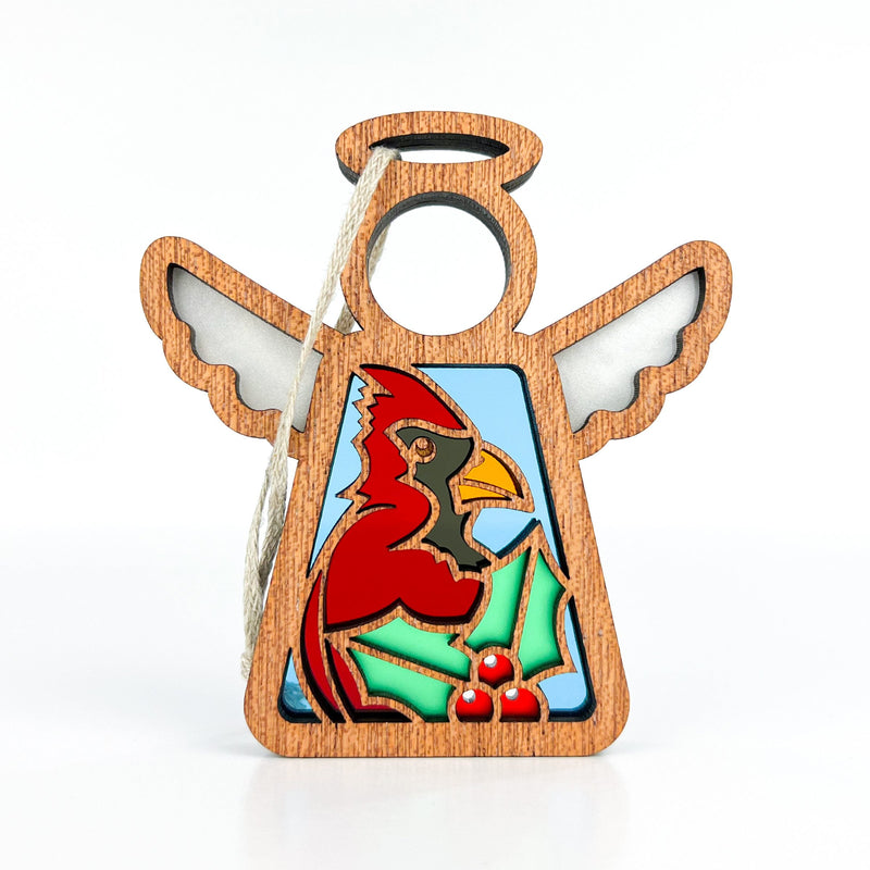 The Forged Flare® Winter Cardinal Ornament with Imperfections is a 3.5" handcrafted Mother's Angels® angel figurine, featuring a cutout cardinal and holly design with hanging twine—perfect as a collectible holiday decoration.