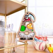 The Forged Flare® Toadstool Mushroom Ornament, a 3.75" Nature's Gnomes™ garden gnome gift, hangs from a metal shelf in a bright kitchen surrounded by toothpicks, glass jars, and colorful bowls.