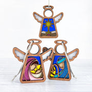 The Forged Flare® Christmas Nativity 3-Piece Bundle includes Star, Mary, and Joseph 3.5" angel figurines by Mother's Angels®, featuring glittery white wings and detailed nativity scenes with the Holy Family.