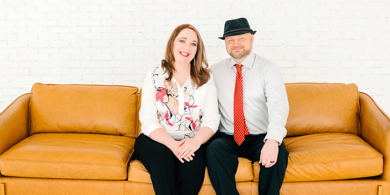 Jen and Chris sitting on a sofa.