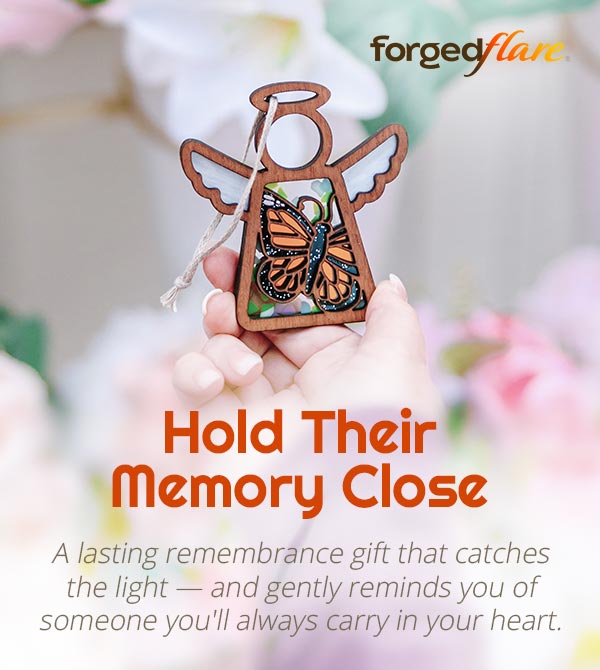 A beautiful monarch butterfly ornament being held up in the sunlight. Text reads: Hold Their Memory Close. A lasting remembrance gift that catches the light — and gently reminds you of someone you'll always carry in your heart.