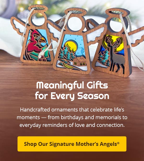 Handcrafted ornaments celebrating life's holiday moments on a wooden surface with a blurred background. Text reads: Meaningful Gifts for Every Season. Handcrafted ornaments that celebrate's life's moments — from birthdays and memorials to everyday reminders of love and connection. Shop Our Signature Mother’s Angels® 