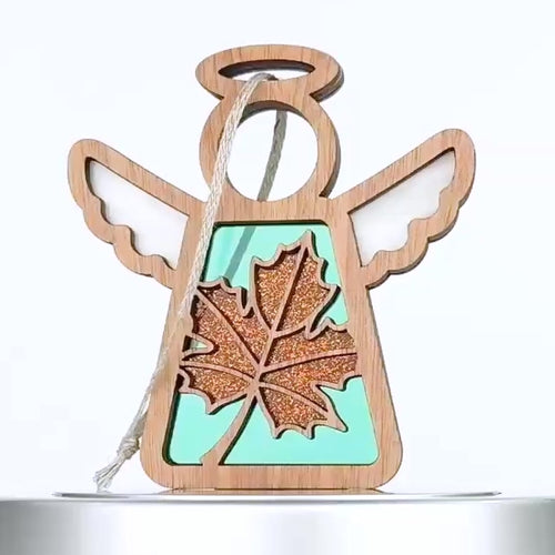 A rotating 360-degree view of the handcrafted Sugar Maple Leaf Mother’s Angels® ornament, featuring a vibrant orange maple leaf with sparkling accents set against a teal backdrop. The ornament’s wooden angel frame and delicate wings create a beautiful autumn-themed design. Perfect for an autumn decoration tree or as a part of fall mantel decor, this sugar maple leaf ornament symbolizes support and solidarity, with 30% of proceeds donated to Samaritan's Purse. Ideal for those seeking autumn decorations.