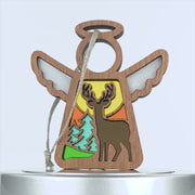 A charming wooden ornament shaped like an angel with white wings. The center features a vibrant scene with a deer, trees, and a bright yellow sun in the background. A string is attached to the top for easy hanging.