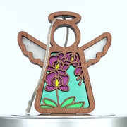 A wooden angel ornament with cutout wings and halo, featuring a multicolored flower design. Purple orchid petals and yellow centers stand out against a blue and teal backdrop. A braided linen string is attached for hanging.