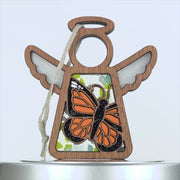 Handmade wooden angel with a stained glass–style butterfly.