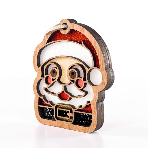 Side view of Santa Sweet Cheeks Christmas ornament showing its layered wood edge, with colors inspired by stained glass
