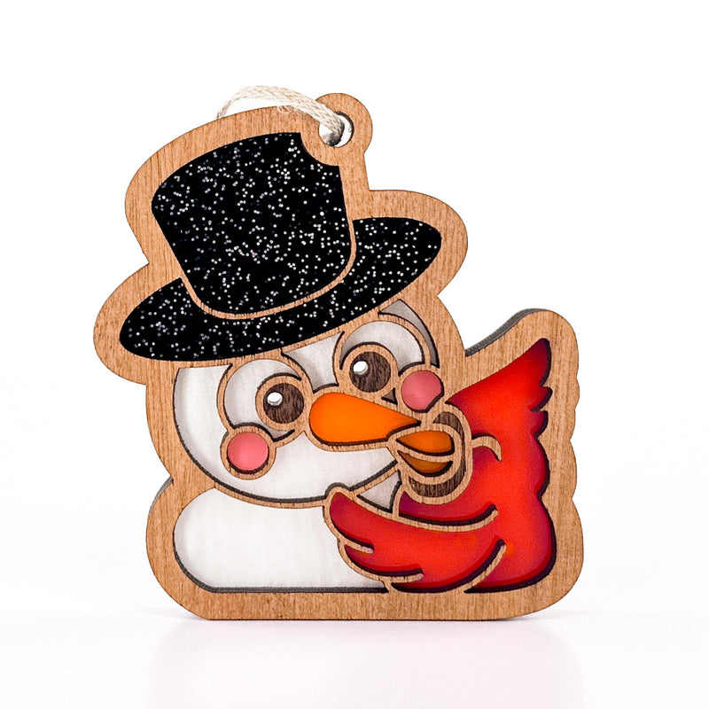 Front view of Snowy Snuggles, a snowman in a black top hat hugged by a red cardinal, a cute Christmas ornament gift