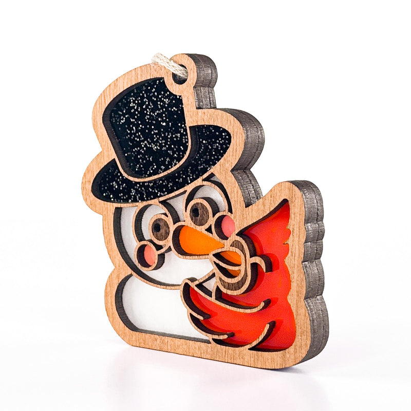 Side view of Snowy Snuggles snowman cardinal Christmas ornament showing its layered wood edge