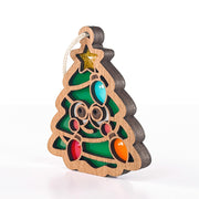 Side view of Twinkle Twinkle Christmas tree ornament showing its layered wood edge and colorful bulbs