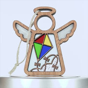 A wooden angel ornament featuring a colorful kite design in the center. The kite, perfect for those who love to fly a kite, is divided into four vibrant sections: red, green, yellow, and blue. The angel has a string attached for display.