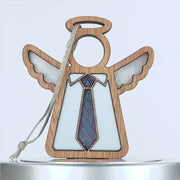 A wooden angel ornament with a hollow circle as a head, white wings, and a light blue body. The angel wears a colorful tie with a geometric pattern, making it an ideal Father's Day gift. A string is attached to the top for hanging.