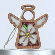 A wooden angel ornament with cut-out wings and a lovely floral design featuring a delicate dogwood flower. The blossom has white petals with a yellow center and a green leaf. A string is attached to the top for hanging against the plain white background.