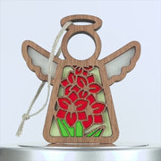 Wooden angel ornament with cutouts, featuring red flowers and green leaves in a stained glass style. The gladiolus ornament has a braided linen string for hanging, making it suitable for holiday decorations or gifts. The background is white.