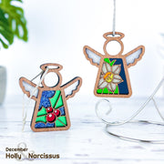 The Forged Flare® Holly Ornament is a 3.5" wooden angel figurine from Mother's Angels®, featuring stained glass holly with red berries, beautifully representing December's birth flower on a white background.