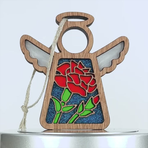 A 360-degree view of an angel ornament featuring a vibrant red carnation flower, perfect as a unique birthday gift for women born in January.